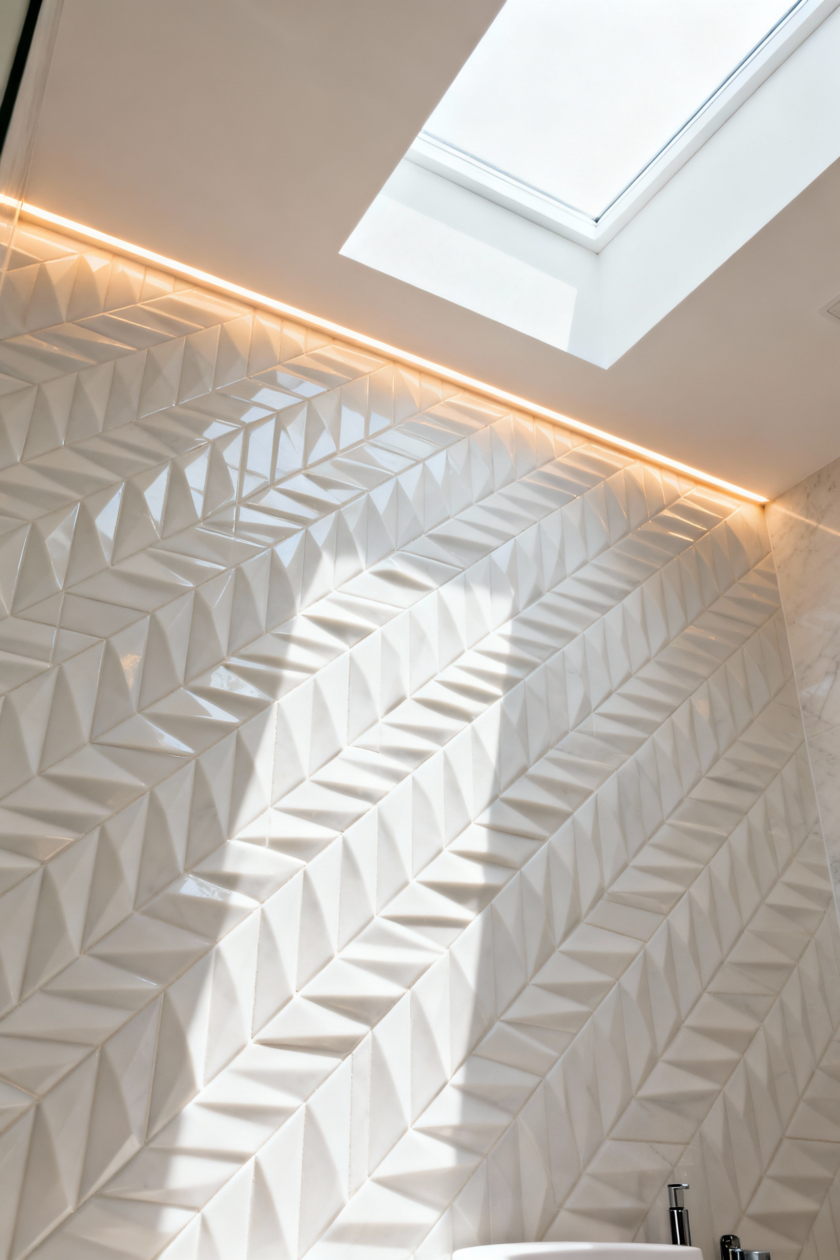 Modern bathroom feature wall covered in pristine white beveled edge tiles, illuminated by natural and artificial light to create captivating patterns of shadows and highlights, enhancing the sense of depth and luxury in a serene setting.